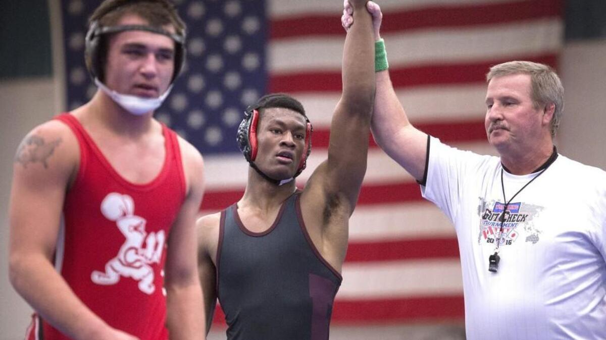 Bethel’s Phillip Springsteen, center, is announced as the winner of the 160-pound championship final, 3-0, over Liberty-Spangle’s Kaleb Hafner in Bremerton.