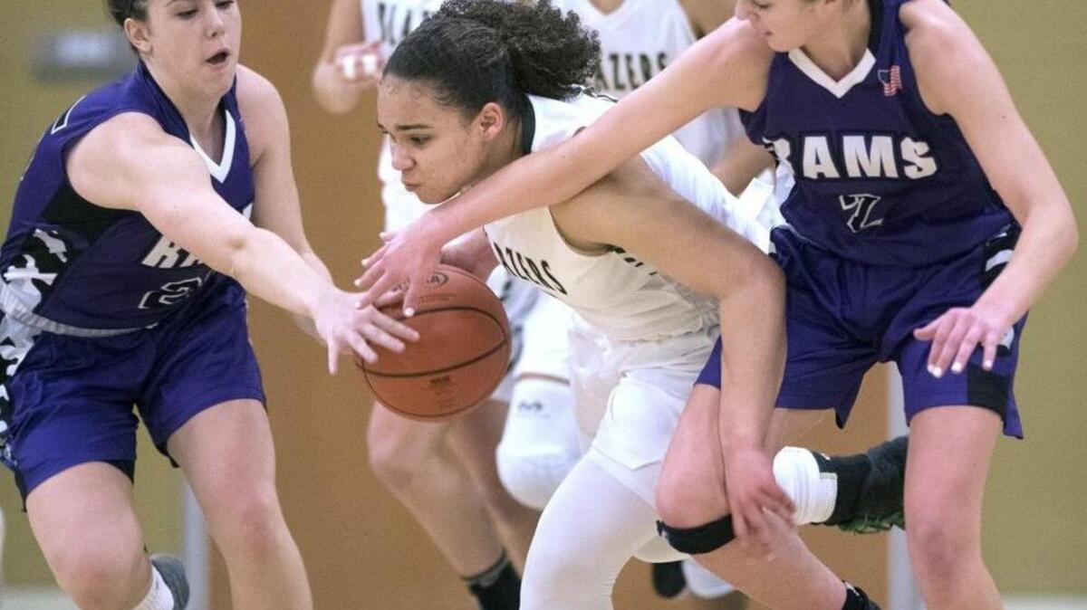 Timberline's Rayanna Dyas (center) fights through the defensive squeeze of North Thurston's Quinlan Christian (left) and Broolyn Harn during Wednesday night's girls basketball game at Timberline High School in Lacey on Jan. 25, 2017.