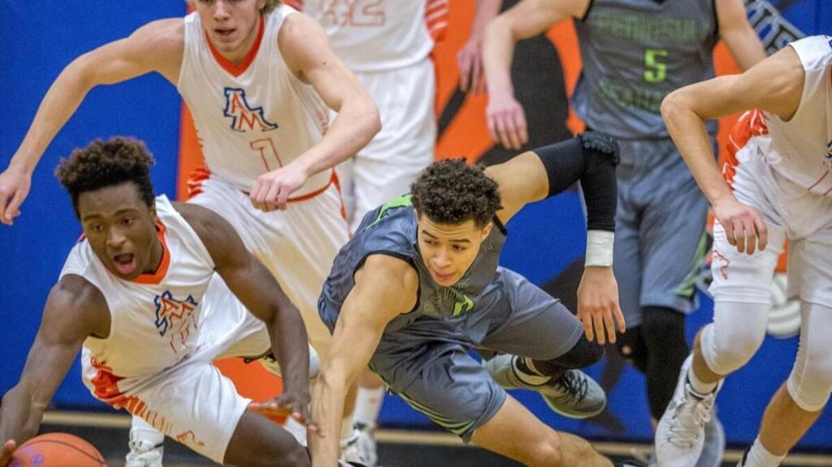 Ki'Jan Weisinger (left) and Talan Alfrey of Auburn Mountainview go for a loose ball along with JaQuori McLaughlin of Peninsula High School in a boys basketball game at Auburn Mountainview, January 8, 2016. Peninsula beat Auburn Mountainview, 58-40.