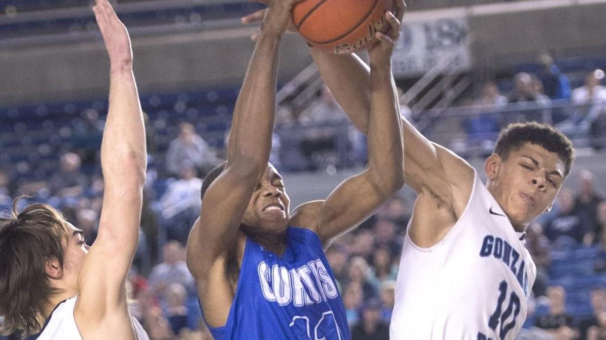 Curtis High's John Moore battles for a rebound with Gonzaga Prep's Sam Lockett, right, and Kea Vargas. Photo taken in Tacoma on Saturday, Mar. 5, 2016. The Vikings lost the consolation game in overtime.