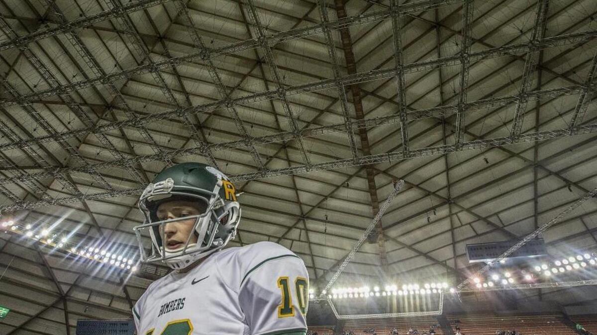 Bombers quarterback Cade Jensen (10) warming up before the Woodinville Falcons and Richland Bombers 4A Washington state football championship game in the Tacoma Dome Saturday, Dec. 2, 2017.