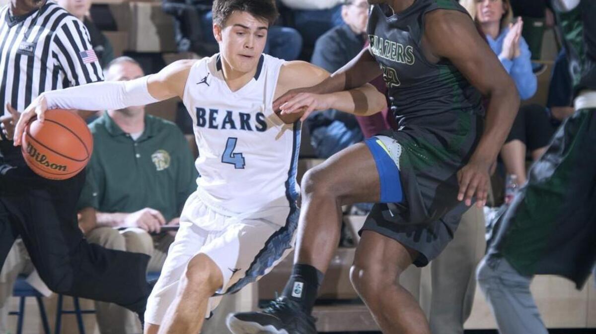 Olympia’s Hunter Sipe drives the baseline against Timberline’s Jarryn Bush on Thursday s 4A Narrows League game at Olympia High School. Olympia won 82-76 in overtime.