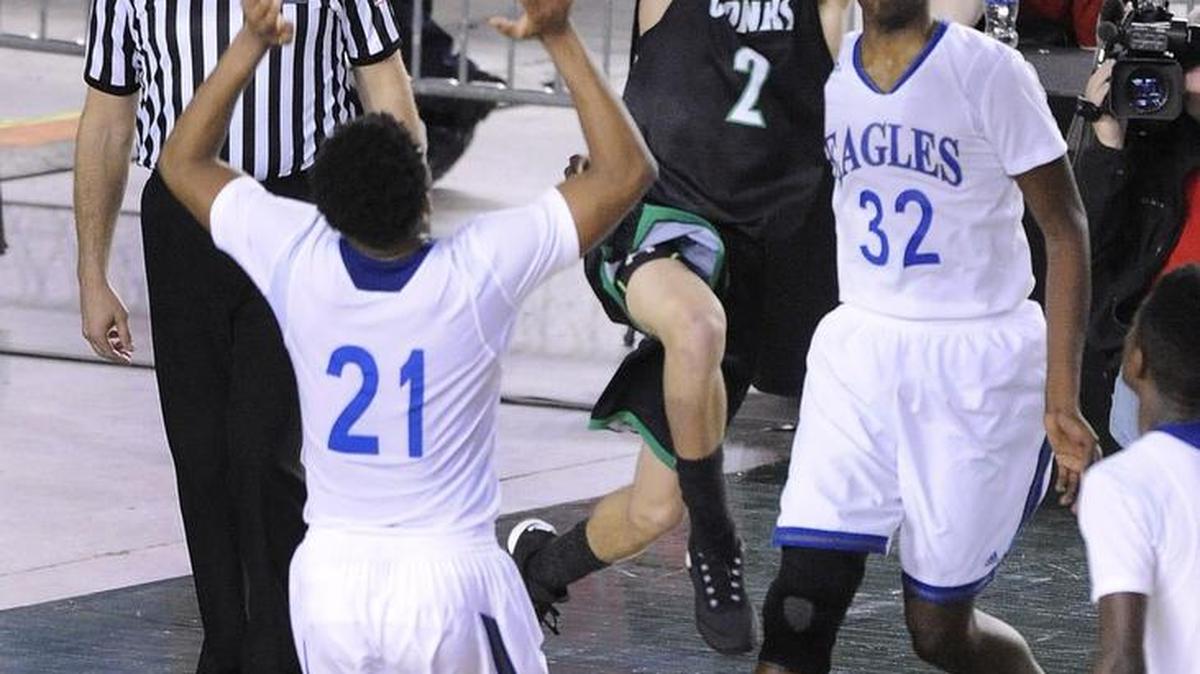 Kentwood's Koby Huerta puts up a shot over Federal Way's Christian Jones in the second half Saturday during the 4A championship game at the Tacoma Dome. Looking on is Malcolm Cola for the Eagles.