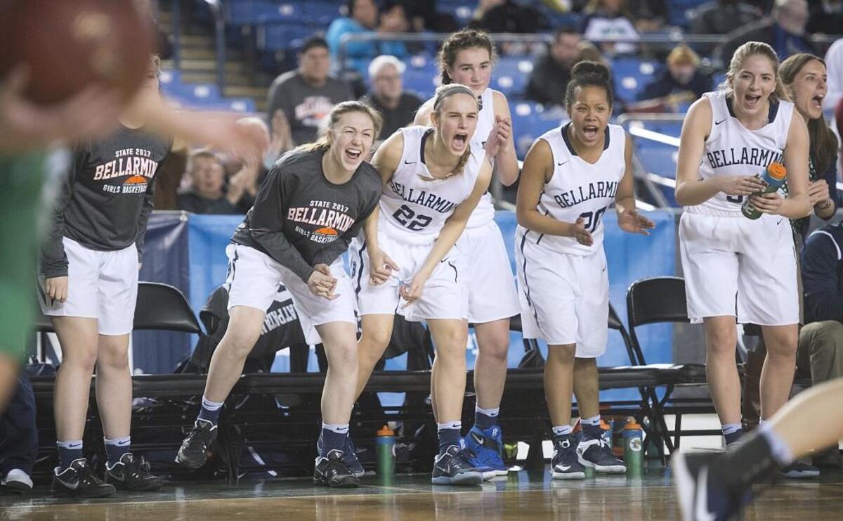 Bellarmine Prep players celebrate as the Lions hold off the Woodinville Falcons for a 68-58 win in their opening-round game of the 4A girls basketball state tournament in the TacomaDome on Wednesday, March 1, 2017.