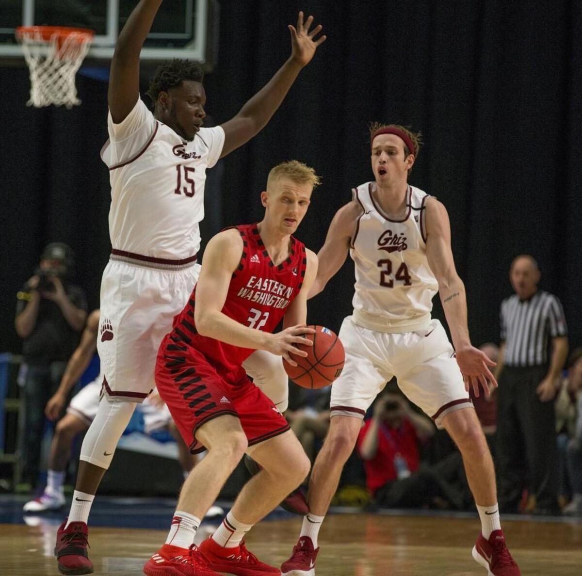 Eastern Washington's Bogdan Bliznyuk, center, is double teamed by Montana's Jamar Akoh (15) and Bobby Moorehead (24) in the second half of their Big Sky Championship NCAA college basketball game in Reno, Nev., Saturday, March 10, 2018.