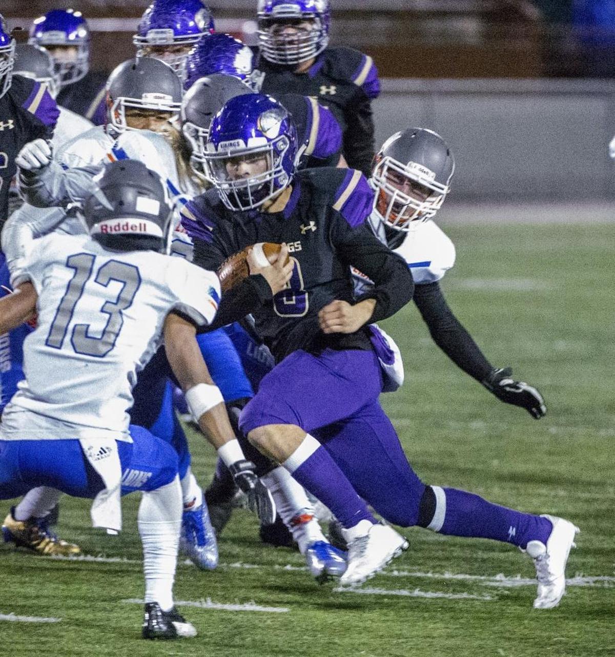Running back Kyle Cramer of Puyallup High School slips through the line against Auburn Mountainview in a 4A football game in Sparks Stadium in Puyallup, November 3, 2017.