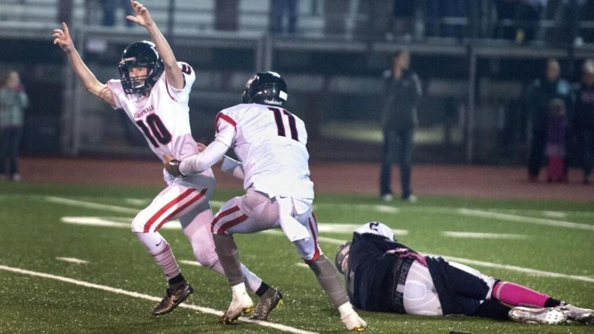 eCardinals kicker Cameron Bowdish rejoices with quarterback Willie Patterson after he kicked the game-winning extra point with no time left. Sprawled on the field after attempting a block is Hawks quarterback/defensive end Kelle Sanders. Photo taken in Lacey on Friday, Oct. 28 2016.
