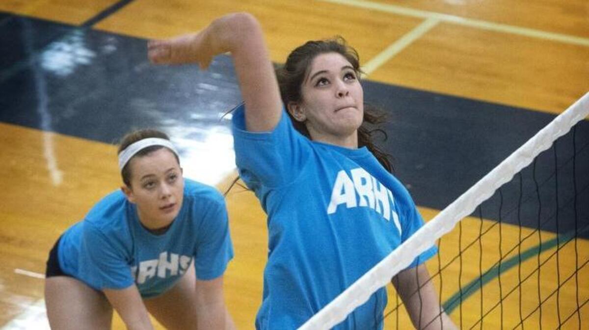 Auburn Riverside’s Kiana Drumheller smashes the ball at net while Kasey Holand backs her up during practice. Drumheller leads the Ravens, the defending 3A state champions, with 188 kills and 121 digs; Holand has 164 kills.