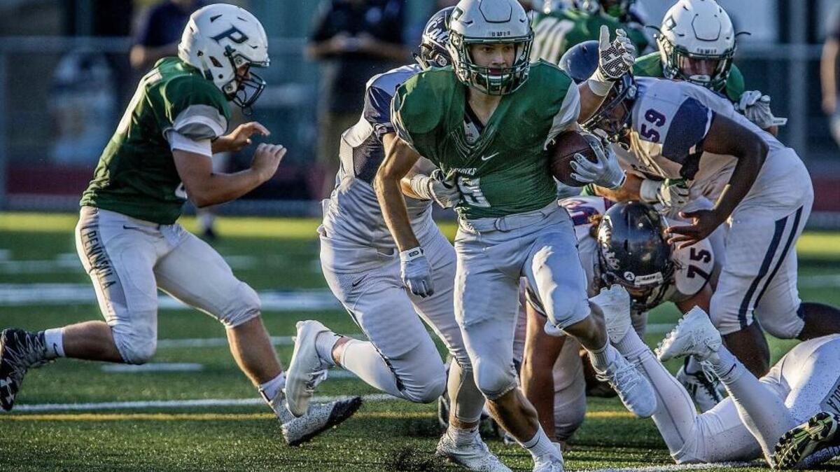 Peninsual High School’s Shawn Leonard (No. 26) breaks out a run for a first down in last week’s loss to Mt. Spokane. This week, the Seahawks look to bounce back against Stadium.