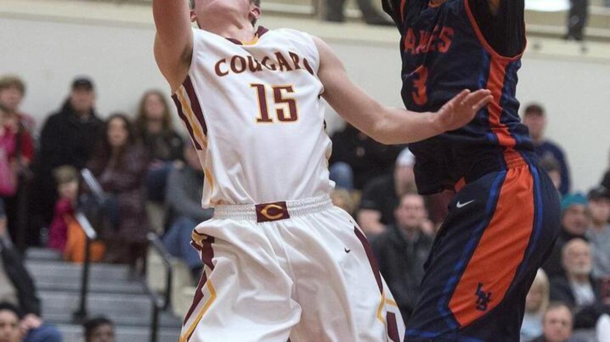 Capital’s Chris Penner (15) flies to the basket against Lakes defender Zachary Nykowski. Penner scored a season-high 28 points to push Capital’s winning streak to nine games.