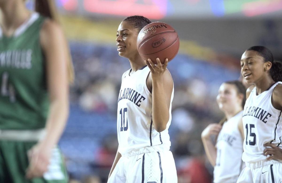 Bellarmine Prep's Shalyse Smith smiles as she goes to the foul line late in the Lions' 68-58 victory over the Woodinville Falcons during Wednesday afternoon's 4A girls basketball state tournament game in the TacomaDome on March 1, 2017.