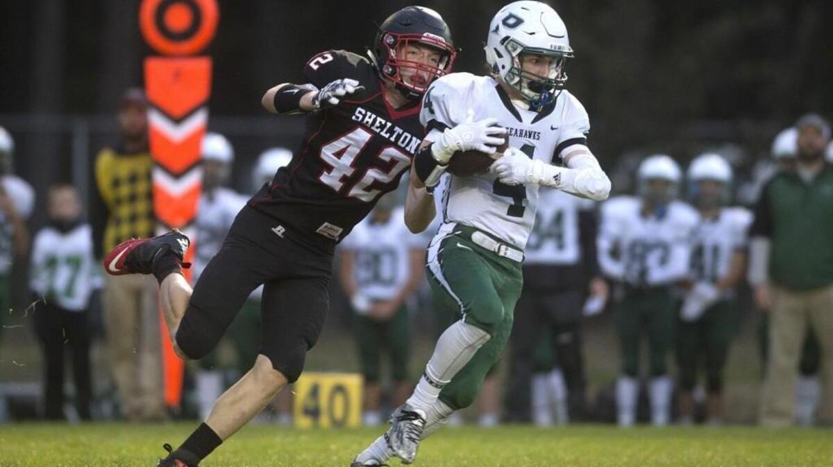 Shelton strong safety Cody Hall tries to chase down Peninsula receiver Alex Beloate Friday night in Shelton.