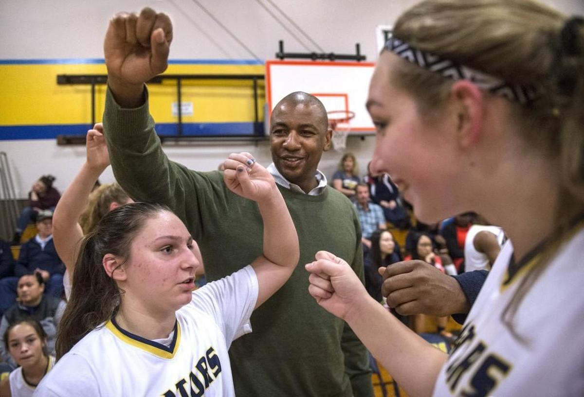 Annie Wright freshman Julianna Walker (from left), head coach Chris Spivey and senior Raquel Berman fire up the Gators during a time out in Wednesday night's girls basketball game against Bush at Annie Wright Schools in Tacoma on Feb. 7, 2018.