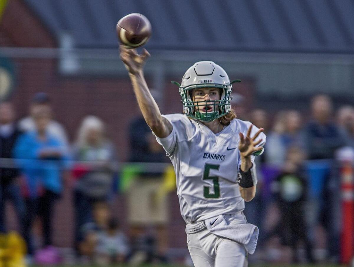 Seahawks quarterback Burke Griffin (5) throws for a first down early in the game. The Gig Harbor Tides face off against crosstown rivals Peninsula Seahawks for the 39th edition of the Fish Bowl at Roy Anderson Field Friday, Sept. 15, 2017. Seahawks win 31-21.