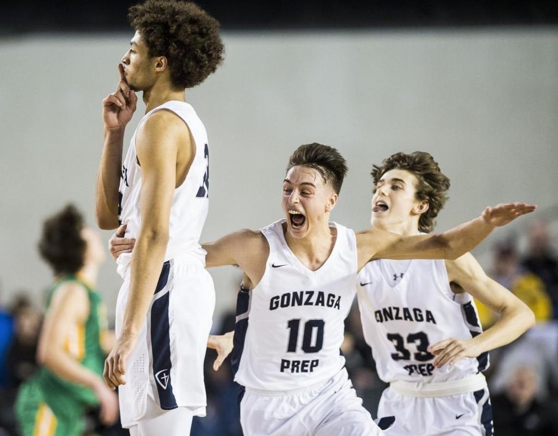 Gonzaga Prep's Anton Watson (32) Jacob Parola (10), and Noah Dryman (33) celebrate Watson's game-winning three point shot. Richland played Gonzaga Prep in a semifinal bracket game at the Hardwood Classic state basketball tournament at the Tacoma Dome in Tacoma, Wash., on Friday, March 2, 2018.
