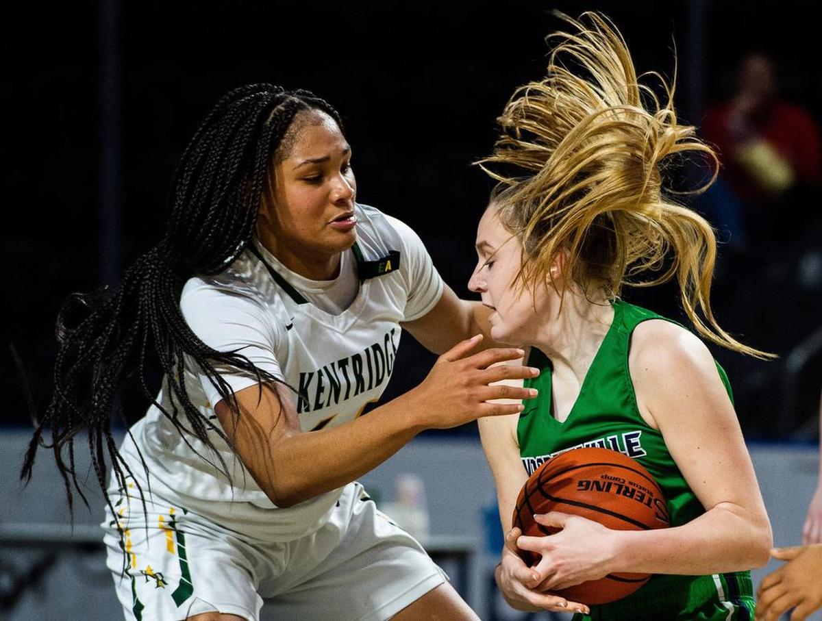 Woodinville’s Mia Hughes (24) and Kentridge’s JaQuaya Miller (44) fight for a rebound in the fourth quarter. Kentridge played Woodinville in a basketball game at the Showare Center in Kent, Wash., on Monday, Jan. 21, 2019.