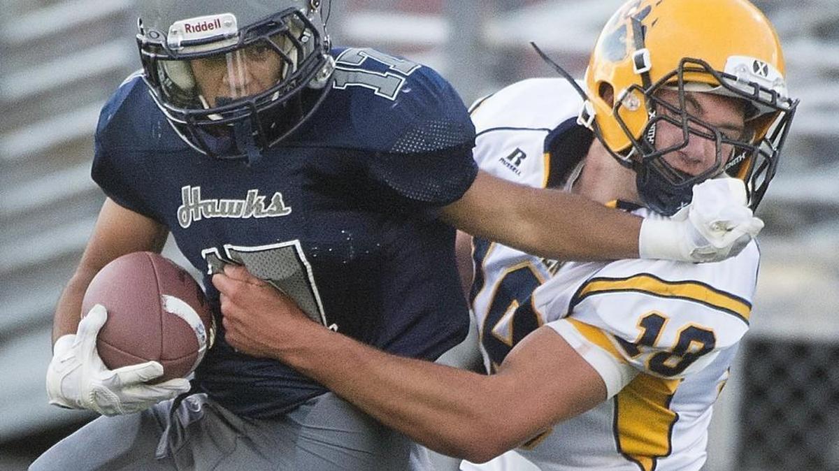 
River Ridge running back Gustavo Diaz tries to fend off Aberdeen linebacker Braden Castleberry-Taylor after a big gain in the first half at South Sound Field in Lacey on Thursday, Sept. 3, 2015.

