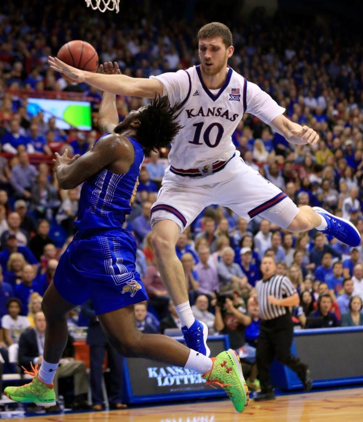 South Dakota State guard David Jenkins Jr. (5) is fouled by Kansas guard Sviatoslav Mykhailiuk (10) during the second half of an NCAA college basketball game in Lawrence, Kan., Friday, Nov. 17, 2017. Kansas won 98-64.