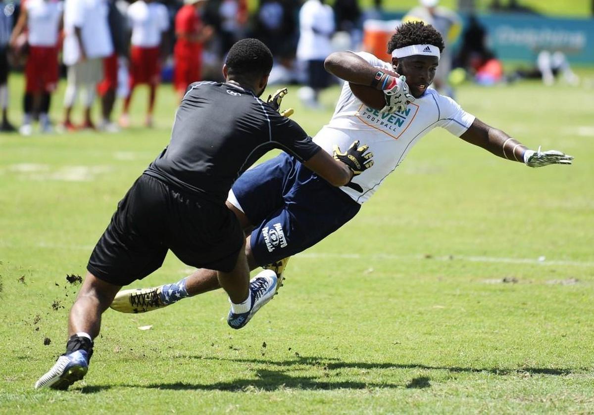 Palmetto high school junior running back Trey Flowers makes a move on a defender during the 9th annual 7 on 7 high school football tournament hosted by the Miami Dolphins at Central Park on June 25, 2016.