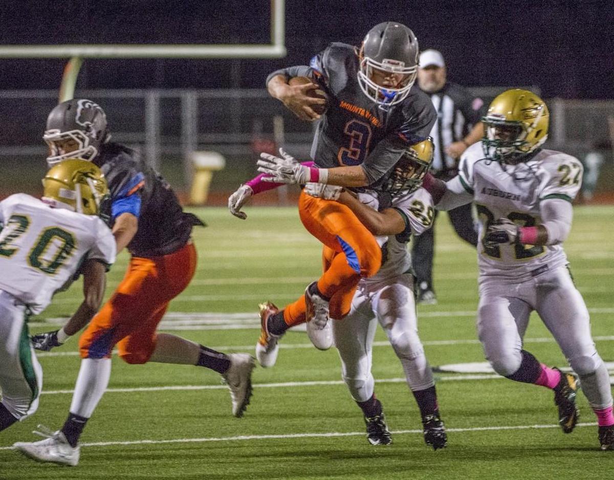 Talan Alfrey of Auburn Mountainview gains a first down while playing quarterback in a football game at Auburn Memorial Stadium, October 7, 2016. Auburn Mountainview beat Auburn 42-21.