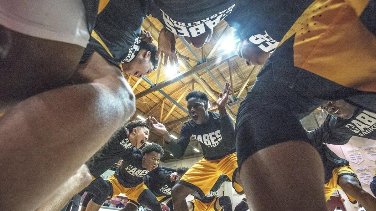 Lincoln players led by Le'Zjon Bonds (center) get psyched up before taking the court Friday 12/16/16 during a basketball game between the Lincoln Abes and the Wilson Rams boys basketball teams at the UPS Fieldhouse.