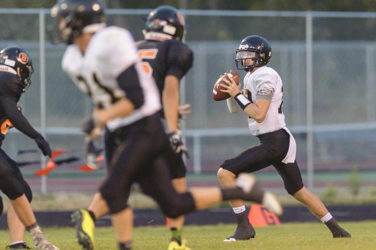 Meridian quarter back Simon Burkett (13) looks for an open man during the second quarter on Friday evening Sept. 8, 2017, at Blaine High School in Blaine, Wash.