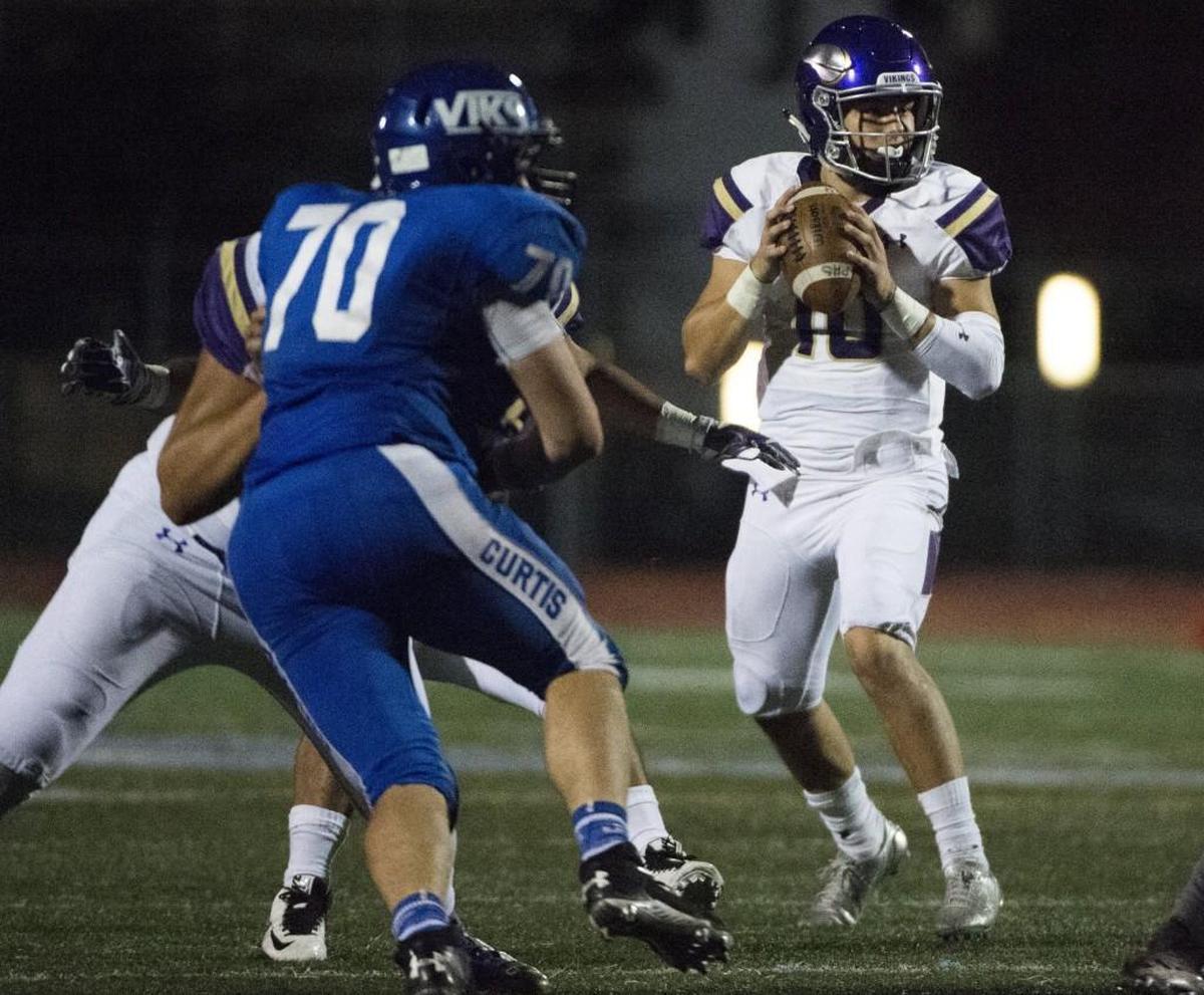 Puyallup's Jacob Holcomb looks to pass during the game. Puyallup played Curtis at Curtis High School in Tacoma, Wash., on Friday, September 1, 2017.