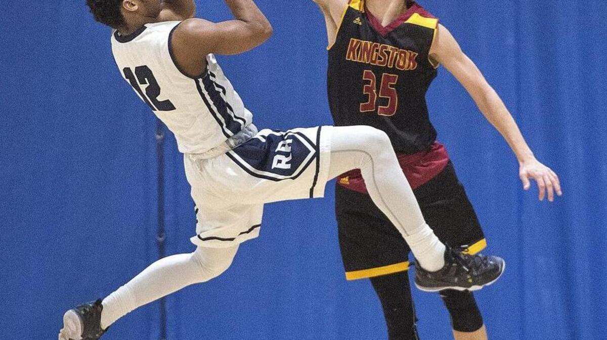 River Ridge’s DeNero Washington puts up a shot against Kingston’s Liam Young. “When we’ve got everything clicking ... we’re a real unstoppable team,” Washington said. “But tonight we just couldn’t do it.”