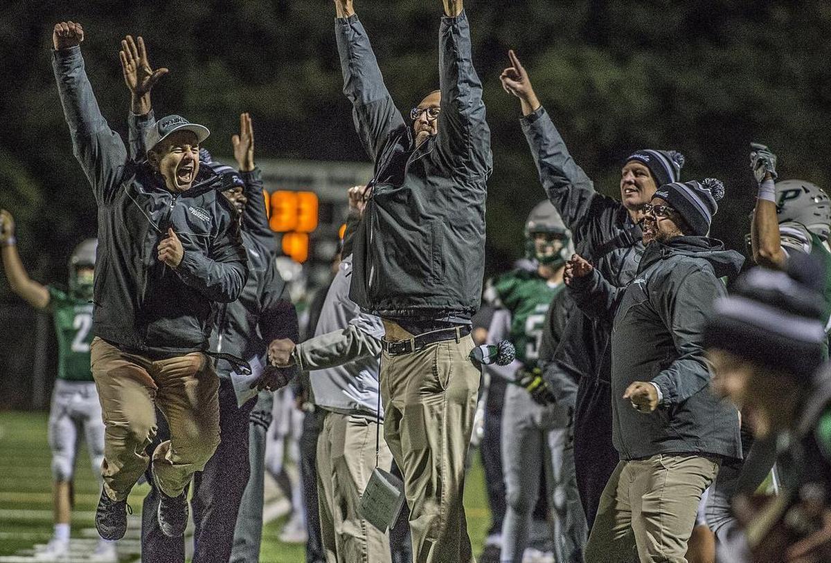 The Peninsula sideline erupted in cheers, including head coach Ross Filkins, center, after the Seahawks recovered a fumble in the fourth quarter of the 3A state quarterfinal football game between Peninsula High School Seahawks and Rainier Beach High School Vikings at Roy Anderson Field in Purdy, Wash., Friday, Nov. 17, 2017.