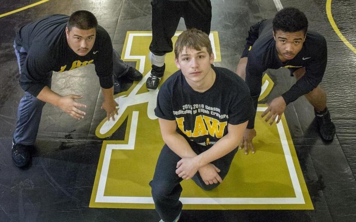 Lincoln High School wrestling coach Greg Ford Jr. with Will Willsey (left, 220 lbs.), JJ Dixon (right, 182) and Jeramias Sandavol (132), December 12, 2016.