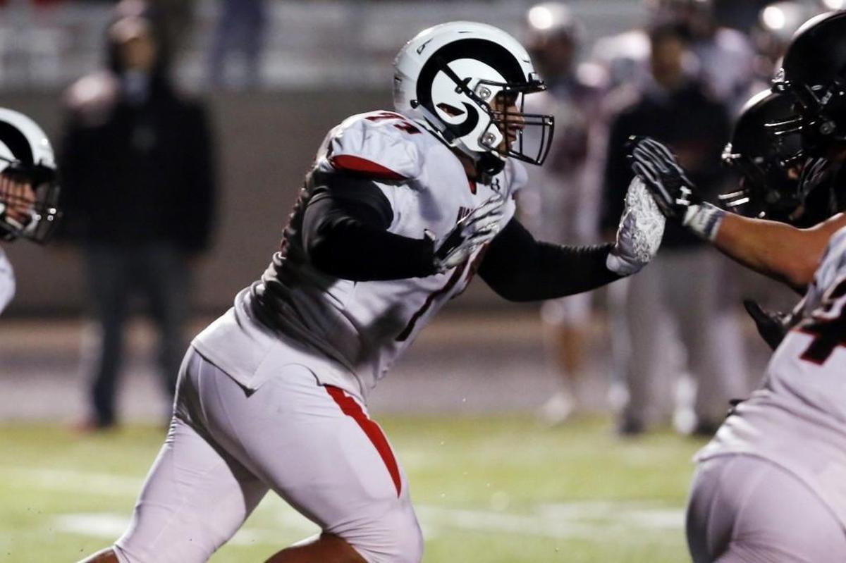 Highland defensive tackle Tommy Togiai breaks upfield during a 5A state semifinal game at Rocky Mountain.