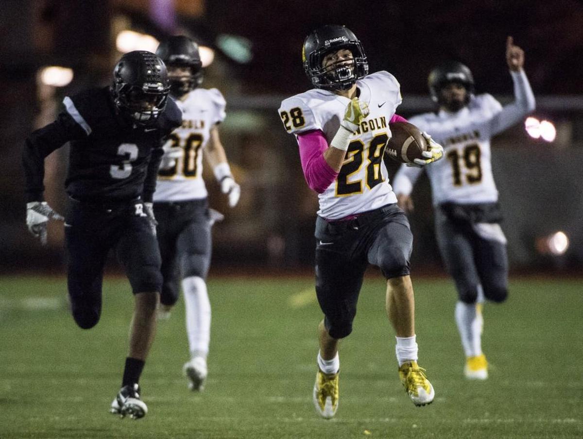 Lincoln's Tristian Kwon (28) breaks away for a touchdown run in the first quarter. Bonney Lake played Lincoln in a football game at Sunset Stadium in Sumner, Wash., on Friday, Oct. 20, 2017.