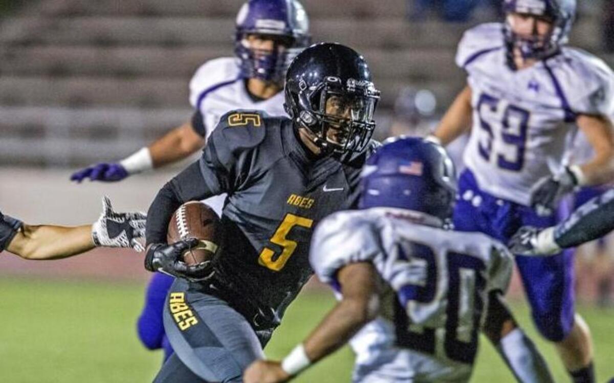 
Lincoln’s Dionte Simon (5), shown carrying the ball against Puyallup last year, has 393 yards rushing in the Abes’ first two games this season.
