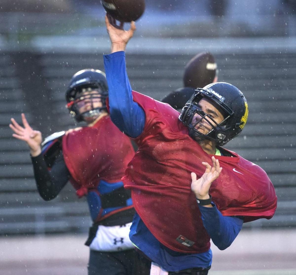 Lincoln quarterbacks (from left) sophomore left-hander Caden Filer and senior right-hander Jaylen Antoine during football practice at Lincoln High School in Tacoma on Wednesday, Nov. 8, 2017.