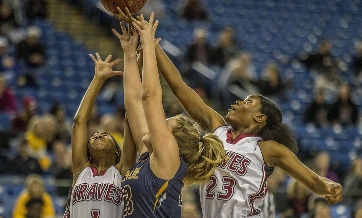 Bethel’s Tirra Brown, right, grabs a rebound during the Bethel Braves vs. Bellevue Wolverines loser-out first-round game in the 3A state girls basketball tournament in the Tacoma Dome. Bethel wins 55-41.
