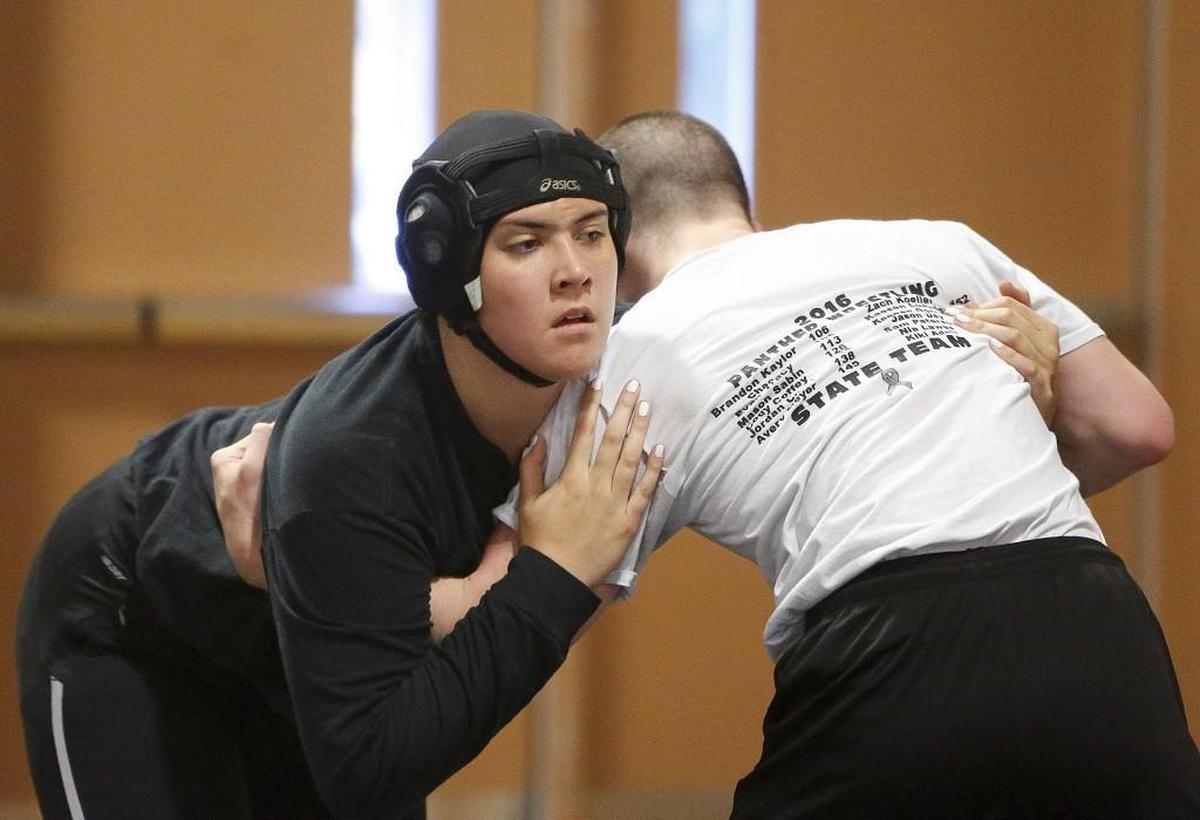 Dreakeanna Adair warms up during wrestling practice at Bonney Lake High School in Bonney Lake, Wash., on Tuesday, November 16, 2016.