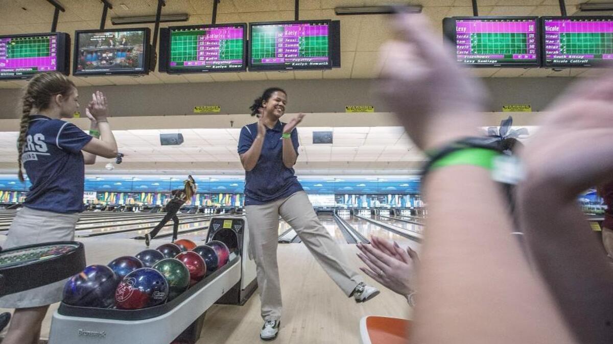 Roger's Kristina Harris dances back to the applause of her teammates after a strike Friday 02/03/17 at Narrows Plaza Bowl during the Girls State Bowling Championships.