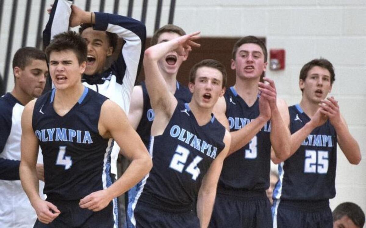 Olympia High School players Hunter Sipe (4), Liam Murphy (24), David Woodward (3), Dayne Shafer (25) and other teammates celebrate a 3-pointer as the Bears jump out to a 30-point lead over the Tigers at Stadium High School in a 4A Narrows League game.