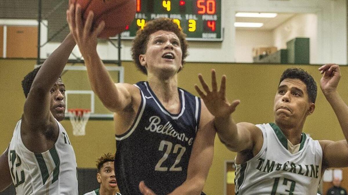 Bellarmine Prep’s Malachi Flynn splits Timberline defenders Jarry Bush, left, and Jaelen Bush to score Wednesday in Lacey. Flynn poured in 34 points in the victory.