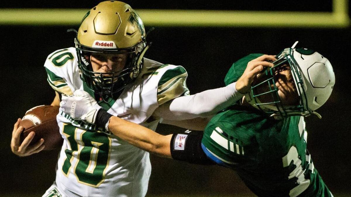 Timberline’s Hunter Campau (10) stiff arms Peninsula’s Ben Goins during a run in the third quarter. Peninsula High School played Timberline High School in a football game at Roy Anderson Field in Purdy, Wash., on Thursday, Sept. 27, 2018.