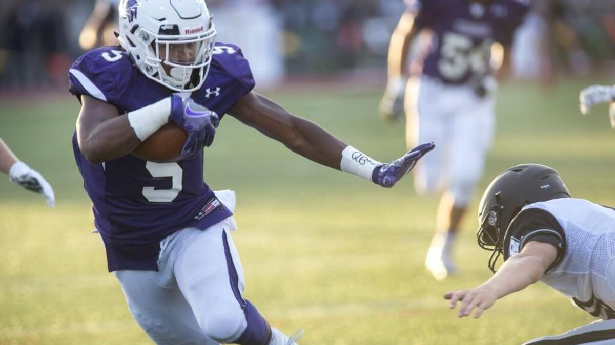 Sumner running back Connor Wedington fends off a Bonney Lake defender to run in a pass for a touchdown. The Spartans travel to Bellarmine Prep this week.