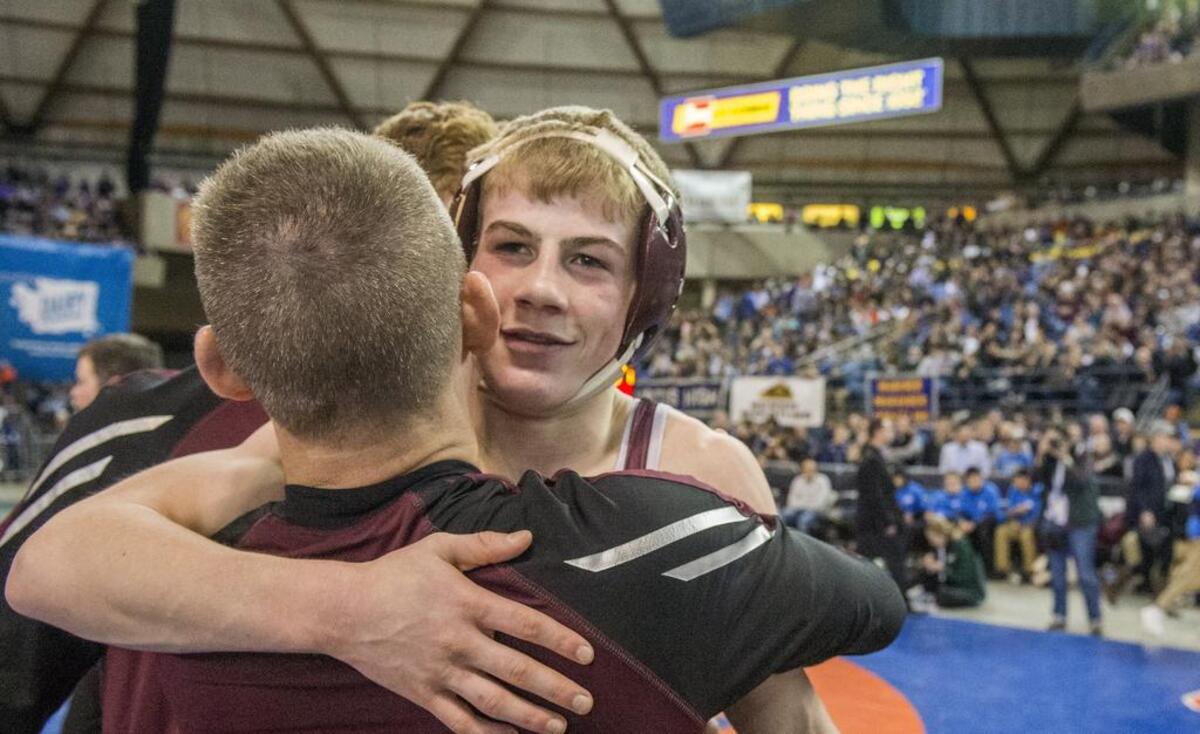 Xavier Eaglin of South Kitsap gets of hug after winning the boys AAAA 106-pound weight class at the Thirtieth Mat Classic state wrestling championships in the Tacoma Dome, February 17, 2018.