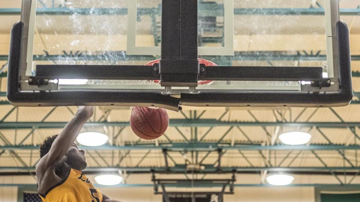 Lincoln forward Willie C Thomas III (5) dunks the ball during Lincoln High School's thrilling 68-62 win against the Spanaway Lake Sentinels at Spanaway Lake Wednesday, Jan. 3, 2017.