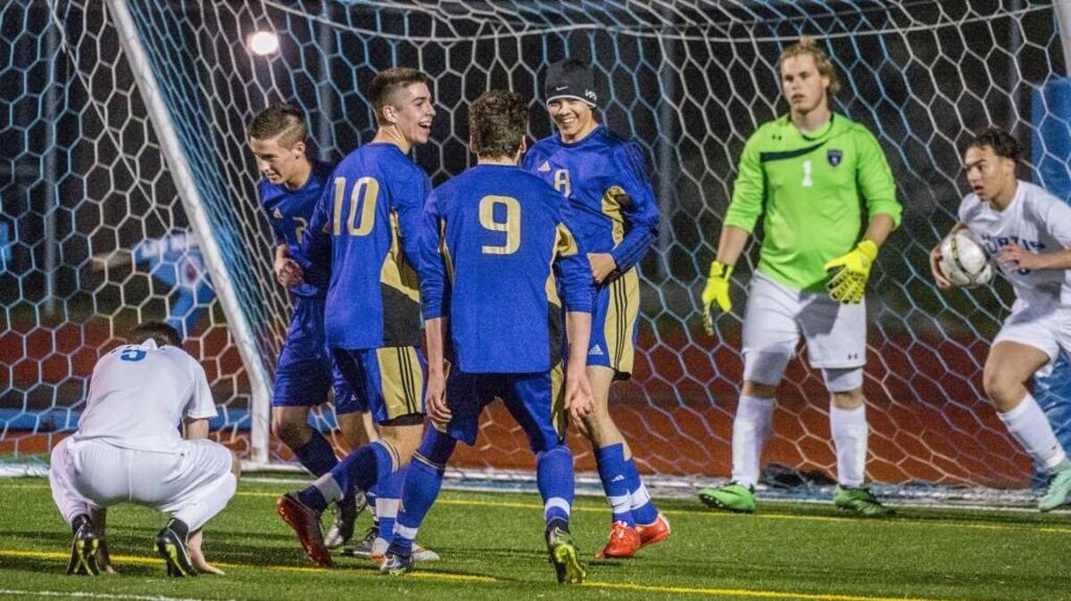 Puyallup’s Kasch Johnson, with hat in center, is all smiles after scoring against Curtis.