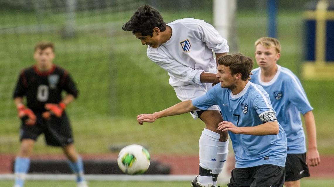 Cris Garfias (left) of Tahoma and midfielder Tanner Stepp of Gig Harbor grapple during a boys soccer West Central District playoff match held at Tahoma, May 16, 2015. Gig Harbor beat Tahoma, 5-0.