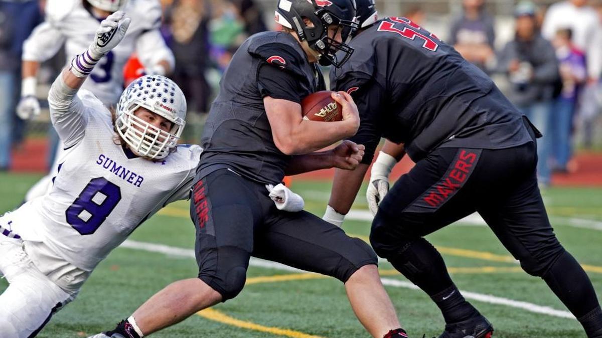 Camas QB Jack Colletto gets past Sumner's Ben Wilson on a keeper for 6. Sumner-Camas in the Class 4A state football semifinal game Saturday, Nov. 26, 2016, at McKenzie Stadium in Vancouver, Wash.
