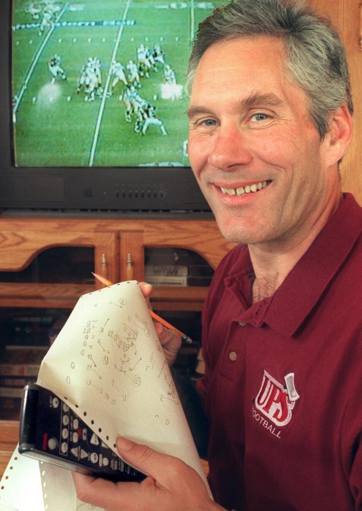 Gordon Elliott, UPS football coach is known for his work on drawing up plays on reams of paper, after reviewing of the video tape of his upcoming opponants football teams. (Russ Carmack/The News Tribune). Photo taken on Nov. 9, 2000.