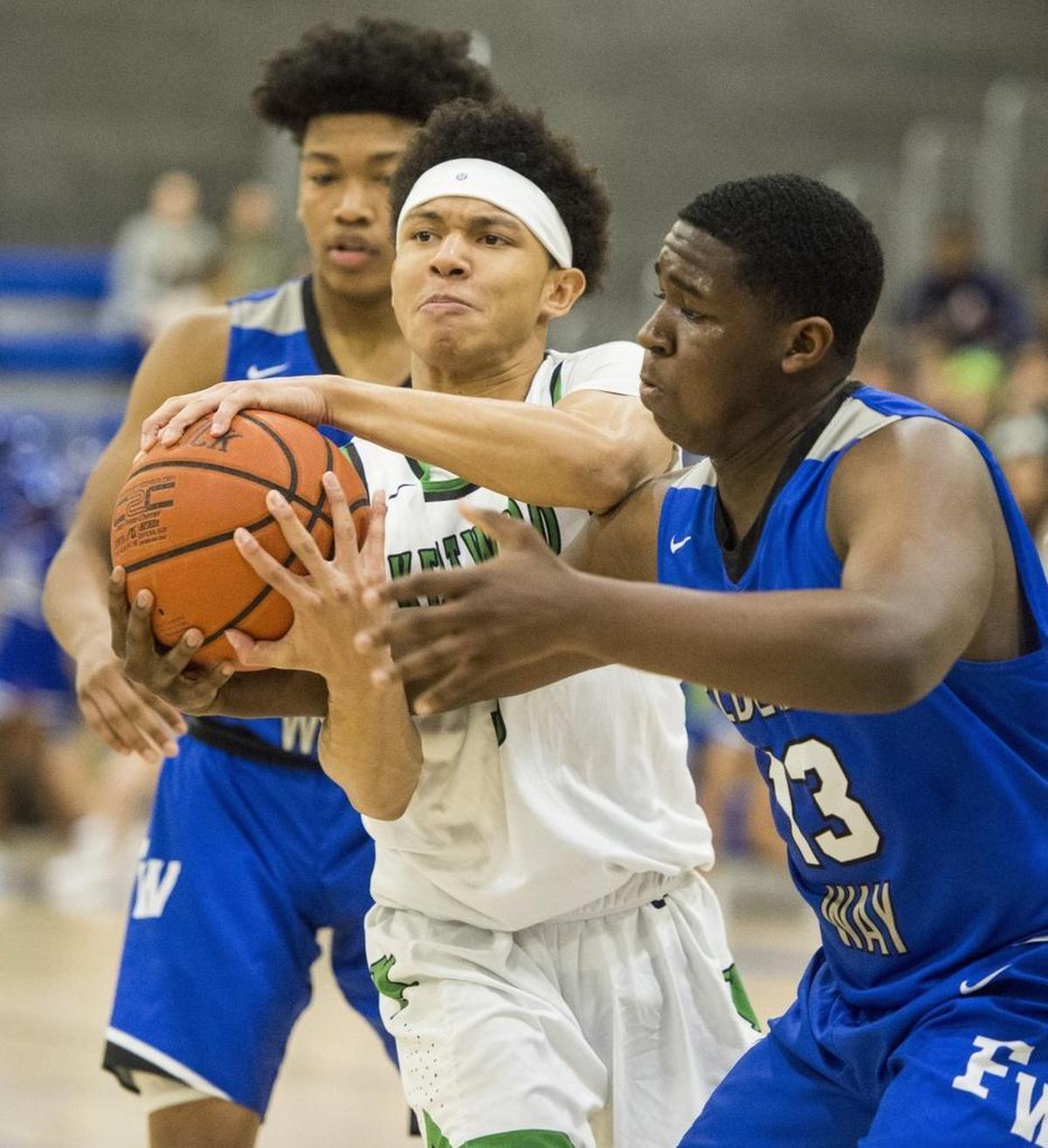 Kentwood's D'Angelo Minnis (5) swipes away a rebound in the first quarter. Federal Way played Kentwood in a basketball game to decide the 4A NPSL title at Tahoma High School in Maple Valley, Wash., on Saturday, Feb. 3, 2018.
