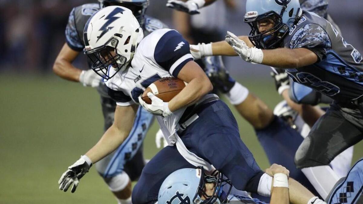 Gig Harbor's defense swarms Squalicum's Triston Smith during a run in the second quarter. Gig Harbor High School played Squalicum High School in a non league game in Purdy, on Friday, September 2, 2016.