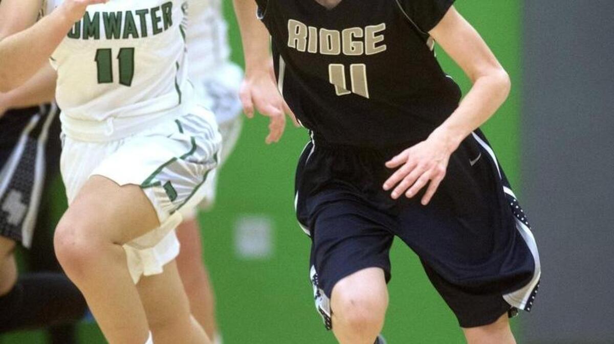River Ridge’s Caitlin Yenne pushes the ball up the court in front of Tumwater’s Sophia Koelsch during the Hawks’ 40-29 victory on Friday night.